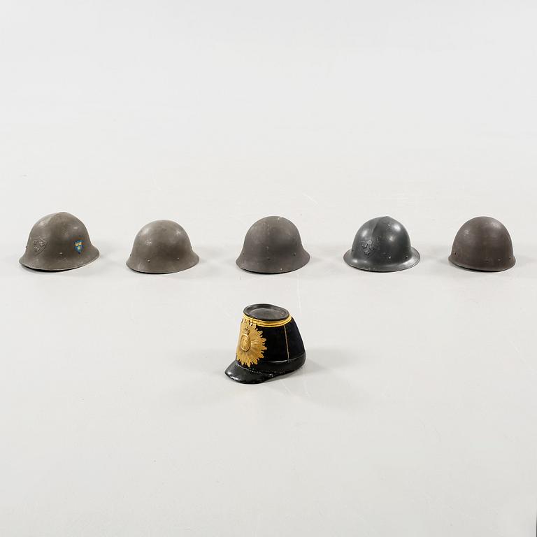 Five military helmets and a hat, late 19th and 20th century.