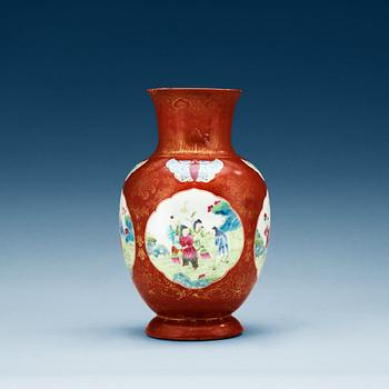 1508. A coral ground famille rose vase, Qing dynasty.