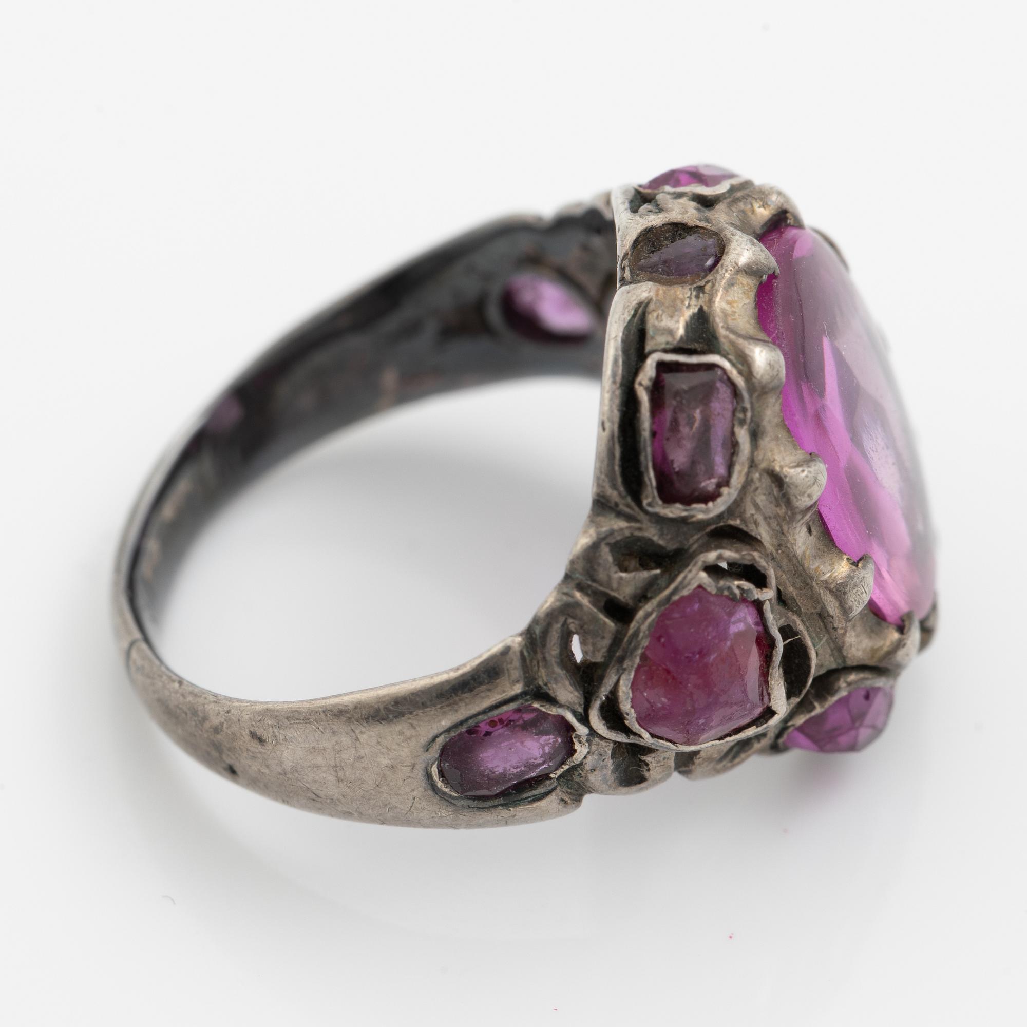 Silver ring with pink stones.