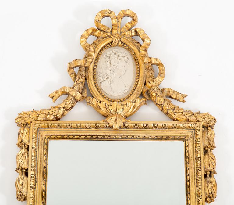A bronzed gustavian style mirror from the second half of the 20th century.