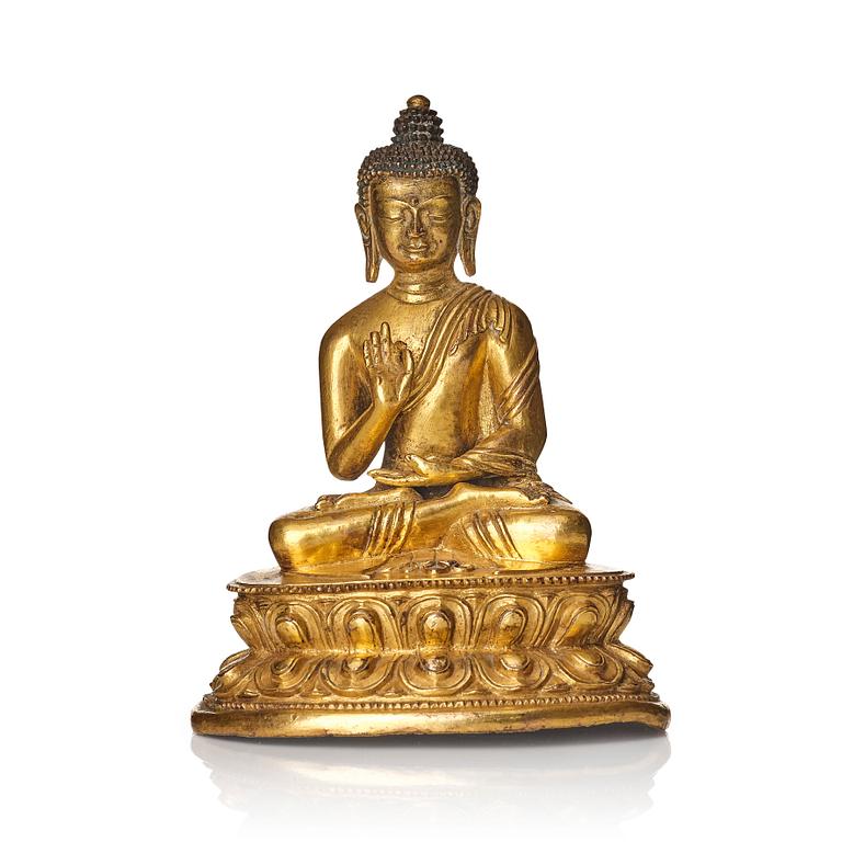 A gilt bronze figure of buddha, Tibet, presumably 18/19th Century.