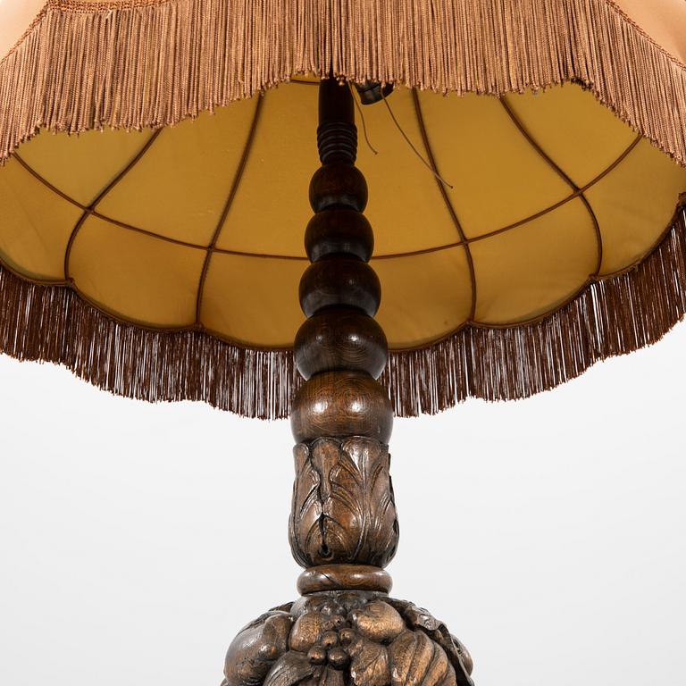 An early 1900s oak floor lamp.