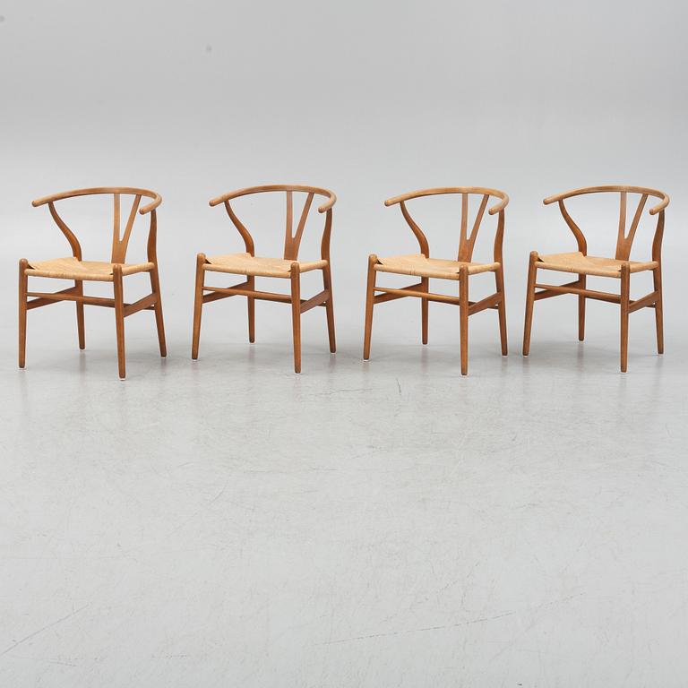 Hans J Wegner, a set of four model CH-24 ”Wishbone” chairs, Carl Hansen & Son, Odense, Denmark.