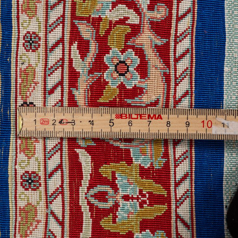 A rug, silk Hereke, ca 143 x 63,5 cm.