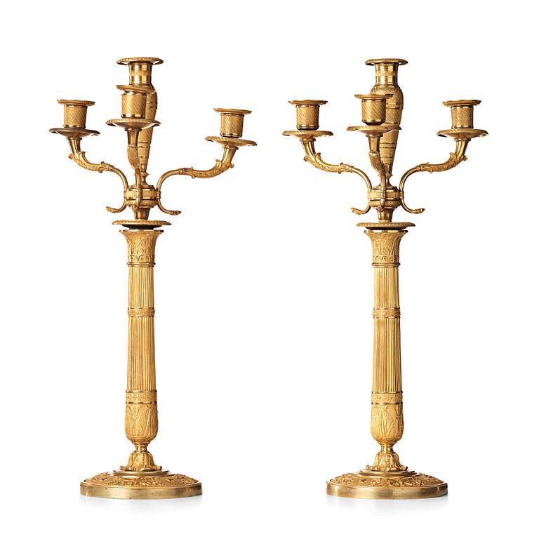 A pair of Empire early 19th century gilt bronze four-light candelabra.