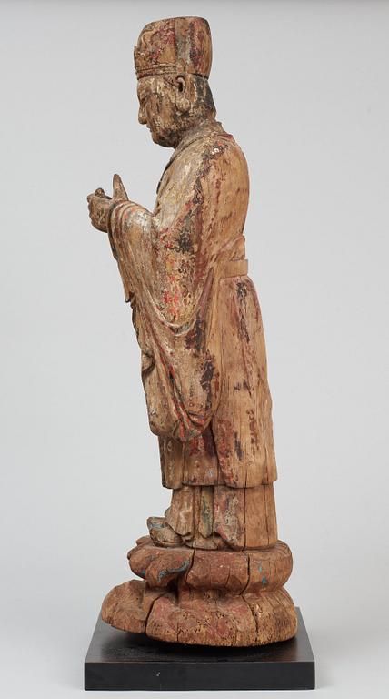 A wooden sculpture of a deity, Ming style.