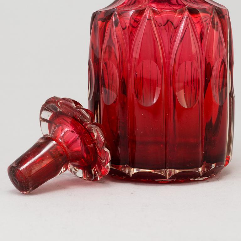 A MID 19TH CENTURY RED GLASS DECANTER AND STOPPER.