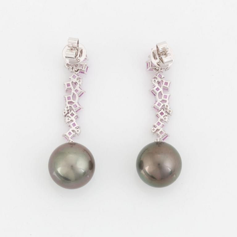 A pair of 18K white gold earrings set with Tahitian cultured pearls and round brilliant-cut diamonds.