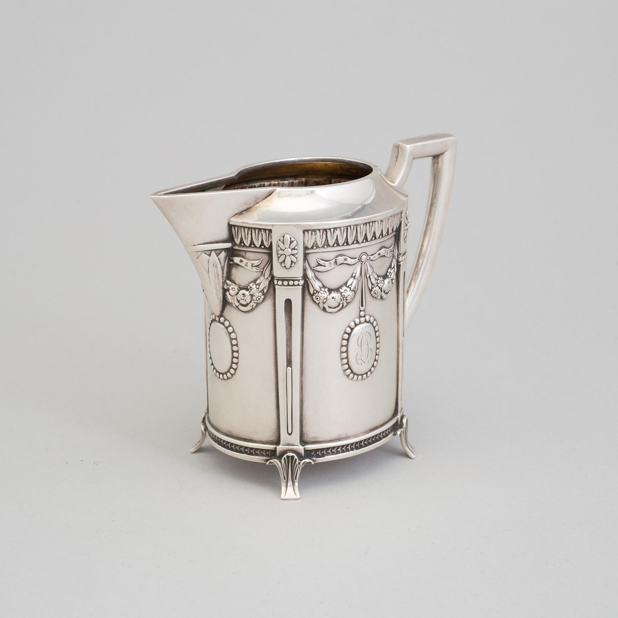 A set of three silver objects (coffeepot, creamer and sugarbowl, CG Hallberg and GAB, Stockholm 1907. Weight ca 1226 gr.
