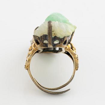 Ring in yellow metal with a white/green stone, possibly nephrite.".