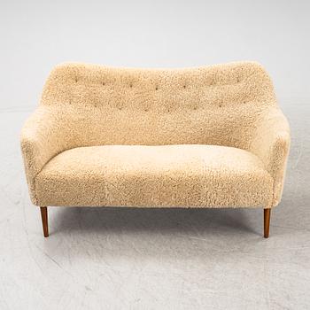 A mid 20th Century sofa with teak legs and new sheepskin upholstery, possibly by Carl Brorup, Slagelse, Denmark.