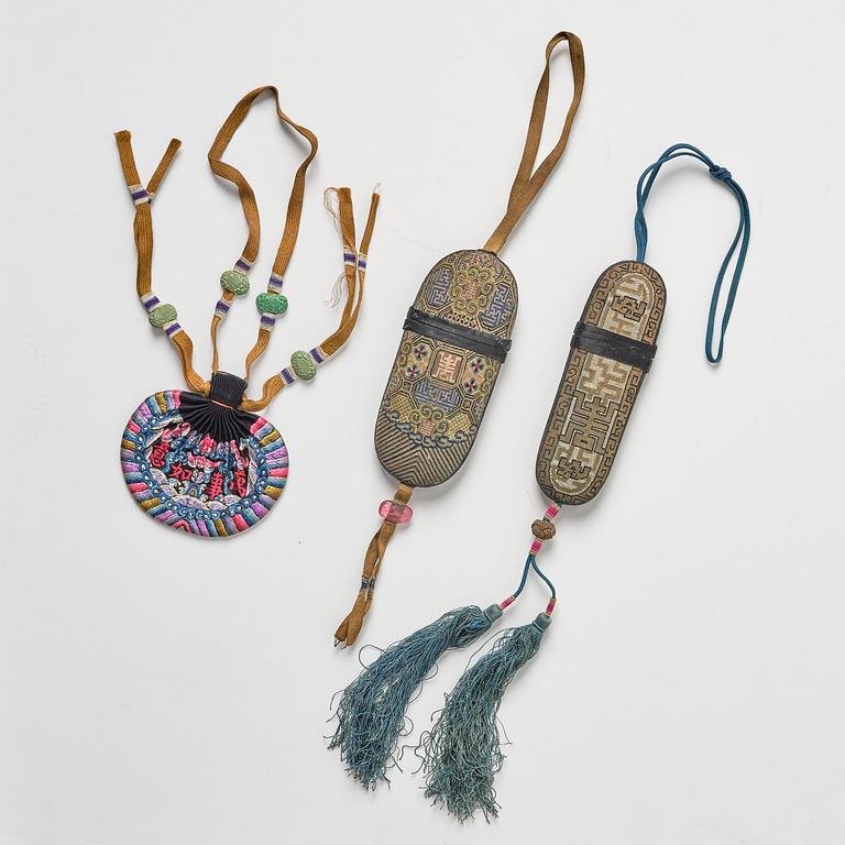 A set of three embroidered purses/ eye-glass cases, Qing dynasty, 19th century.