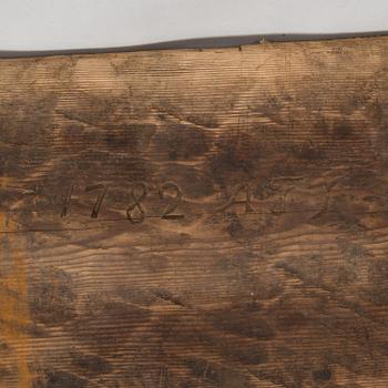 An 18th-century wooden bench dated 1782 with initials.