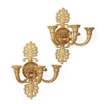 66. A pair of French Empire early 19th century three-light wall-lights.