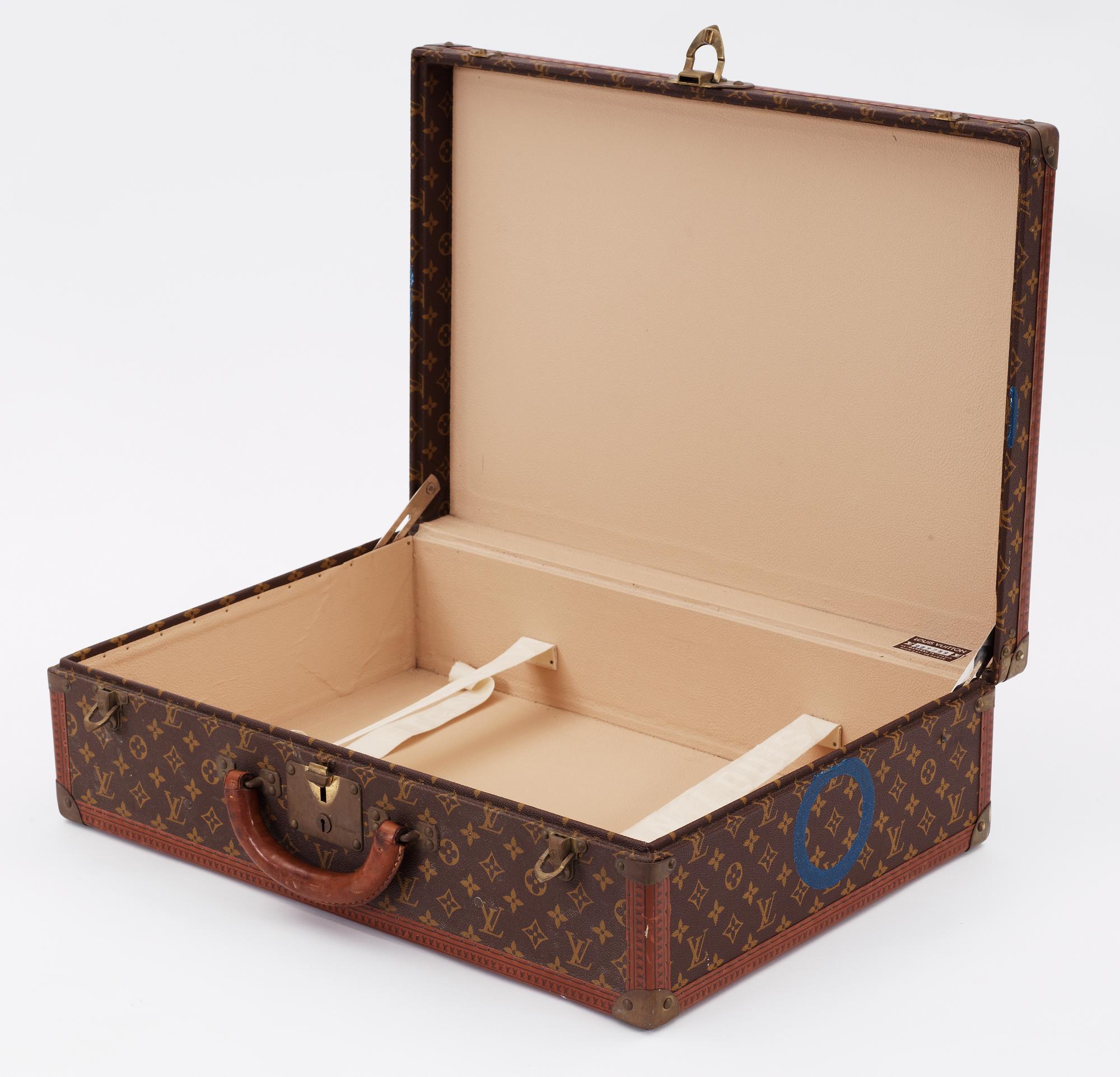 A monogram canvas suitcase by Louis Vuitton.