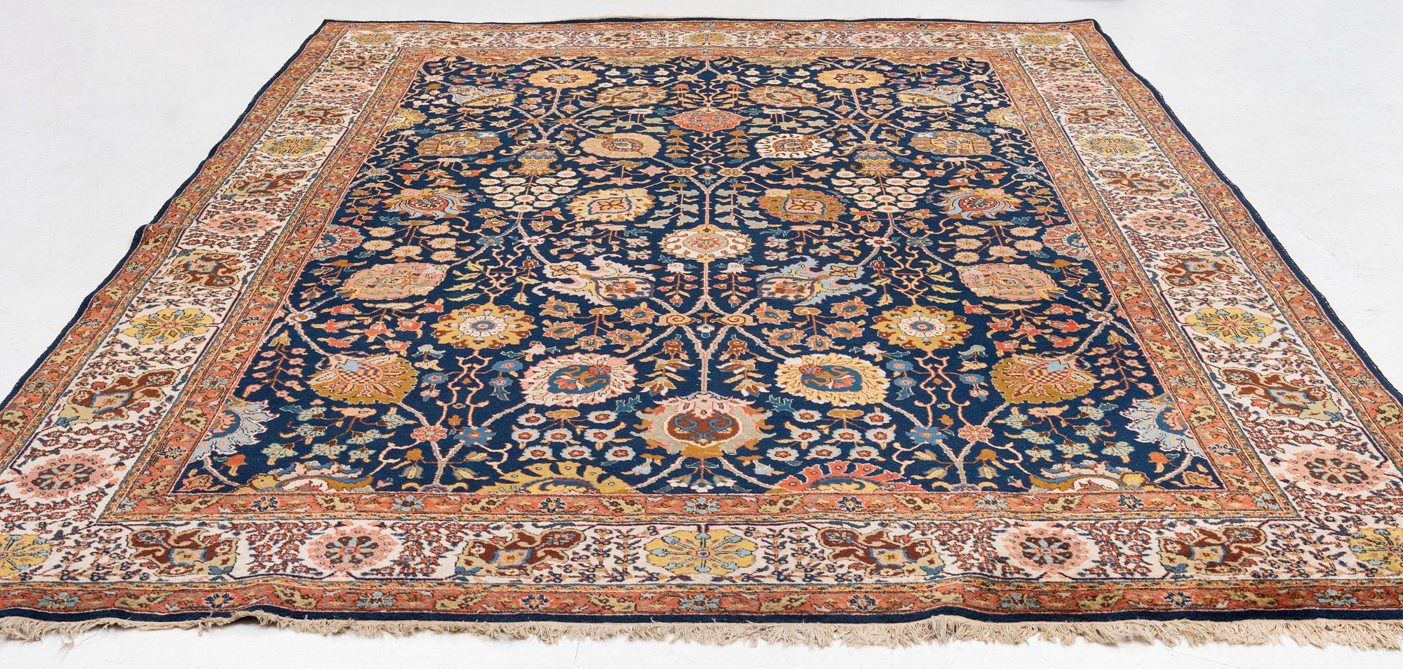 A semi-antique Tabriz carpet, c. 395 x 295 cm.
