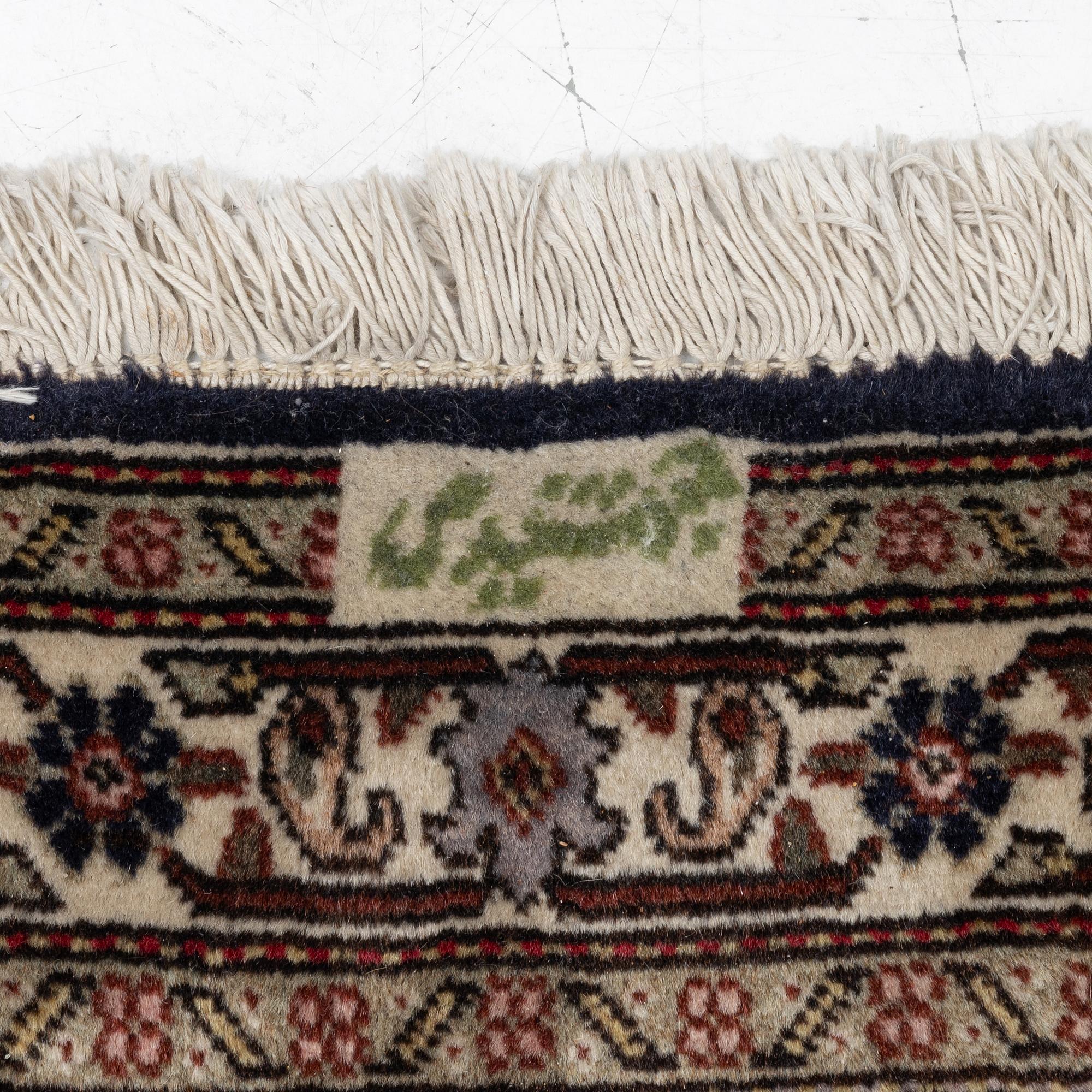 A signed Tabriz carpet, c. 385 x 300 cm.