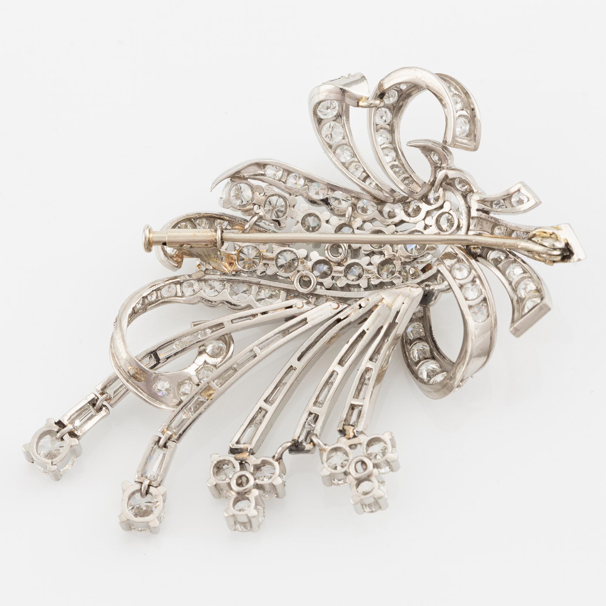 A platinum brooch with round brilliant and baguette-cut diamonds.