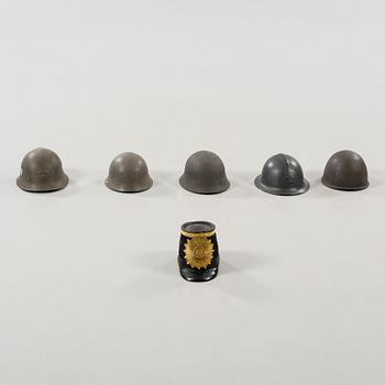 Five military helmets and a hat, late 19th and 20th century.