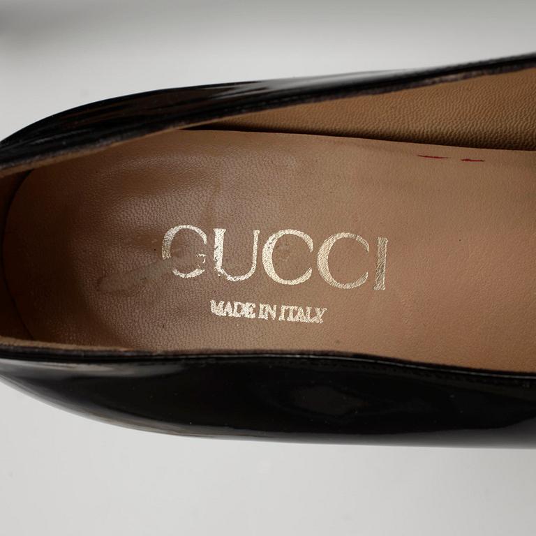 GUCCI, a pair of black patent leather shoes.