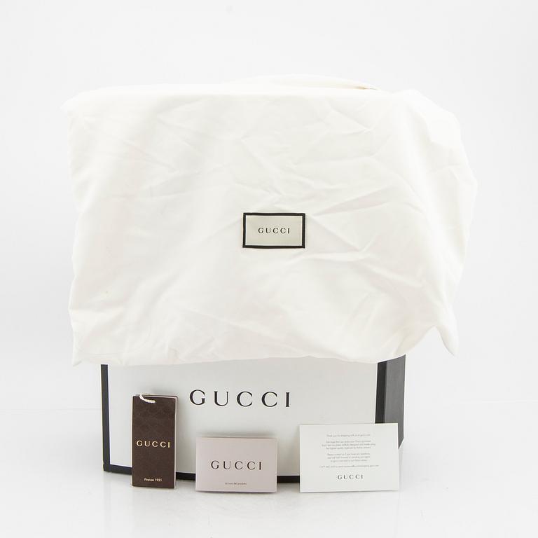 A Gucci diaper bag.