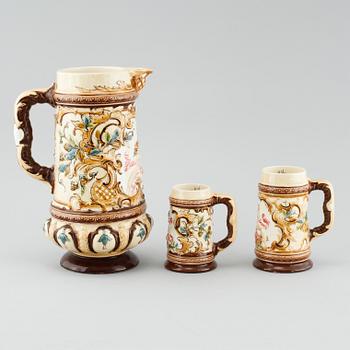 A jug and twelve beer mugs, majolica, around turn of the century 1900.