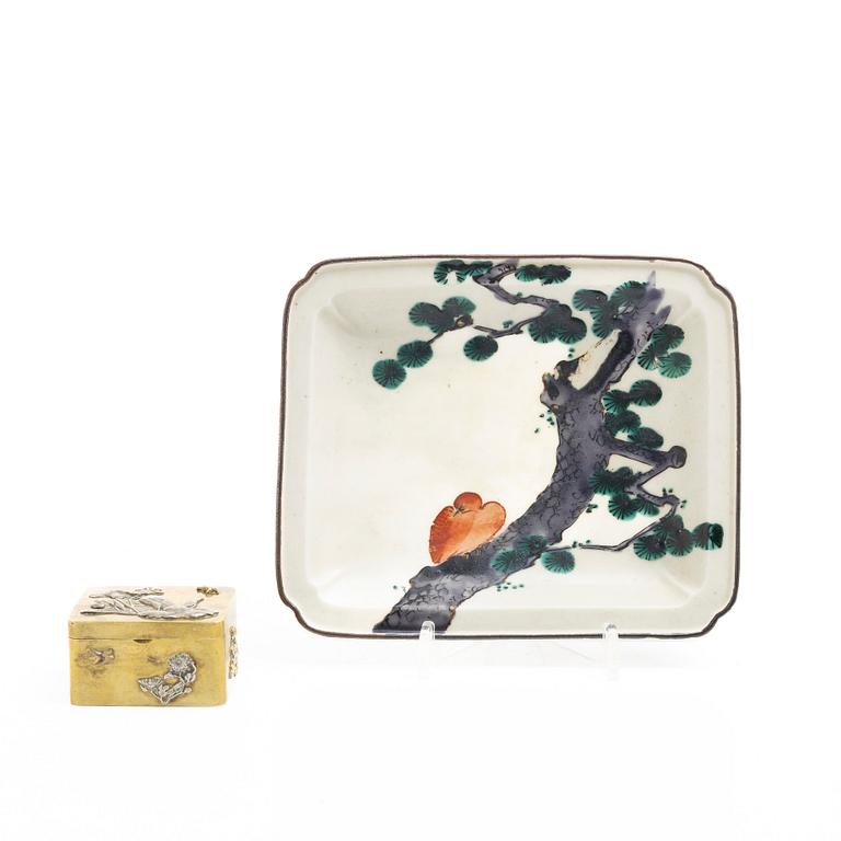 A small Japanese gilt copper box with cover and a porcelain dish, 19th century.