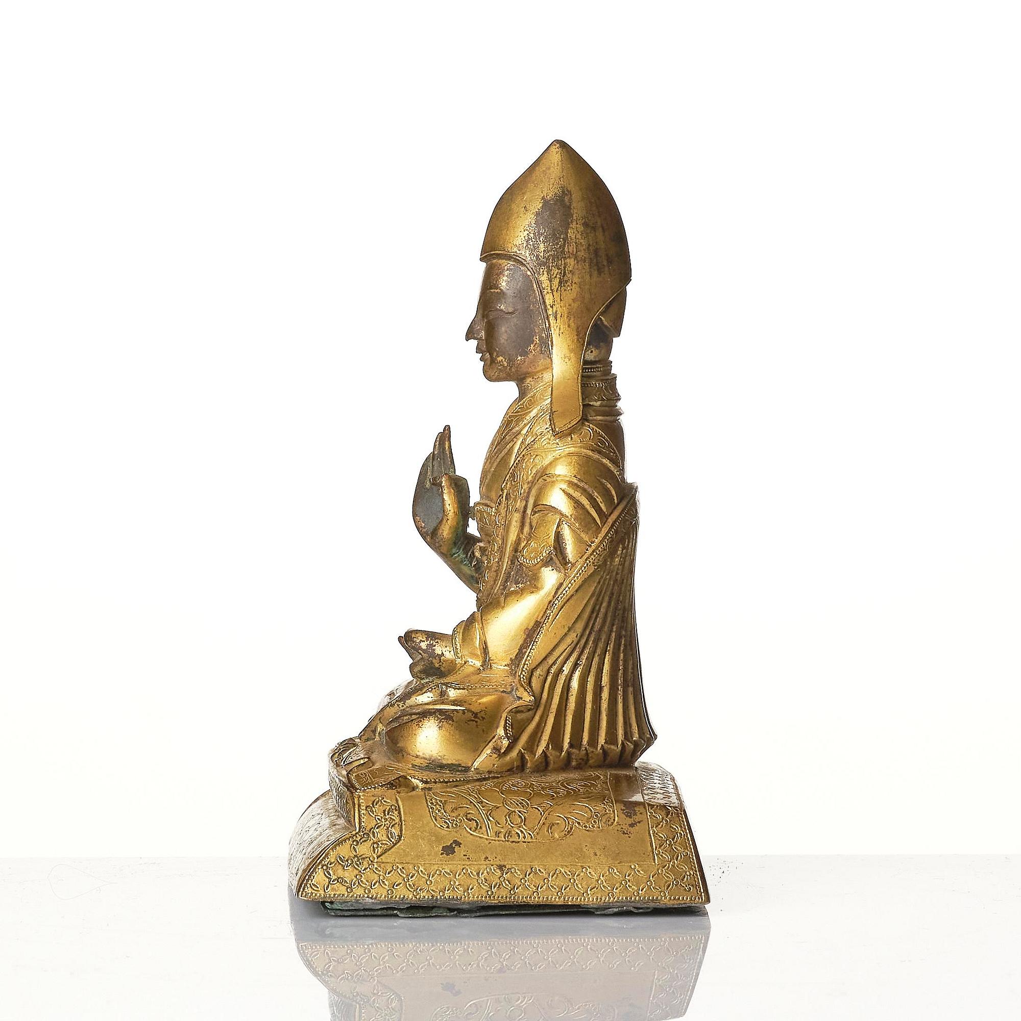 A gilt bronze figure of a Lama, Tibeto-Chinese, 18th/19th century.
