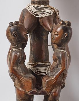 A sculptue and two masks reportedly from The Ivory coast, from the second half of the 20:th century.