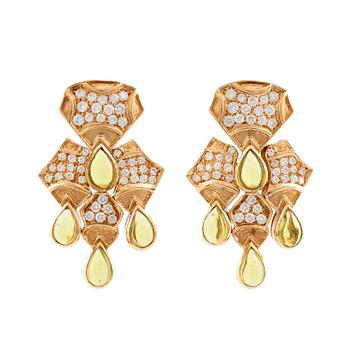 528. A pair of cabochon cut peridot and round brilliant cut diamond earrings.