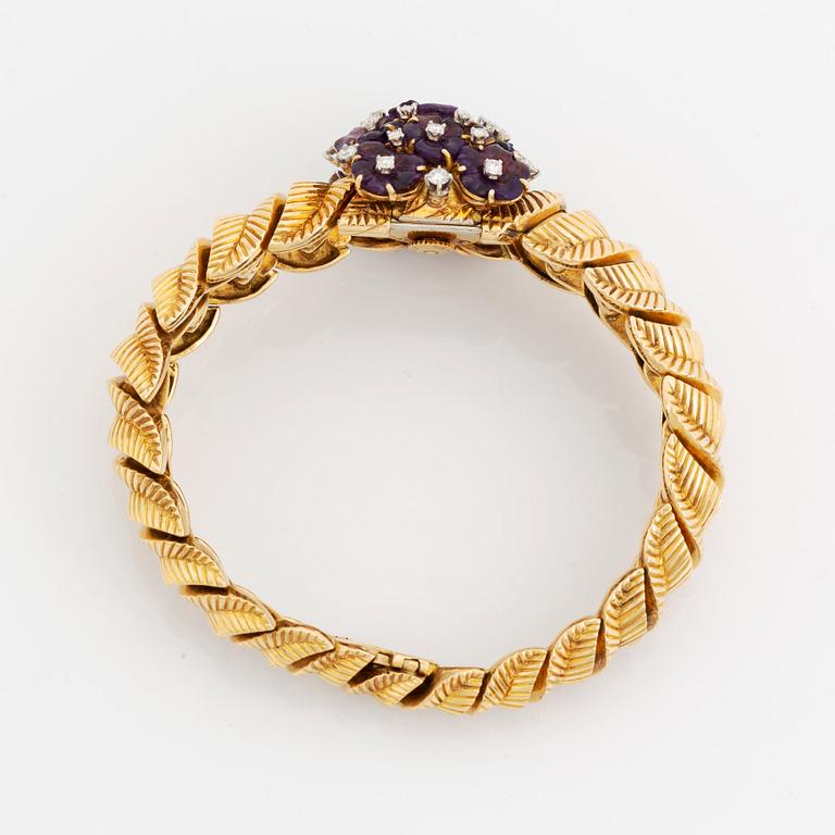 A Gübelin bracelet/wristwatch in 18K gold set with amethysts and round brilliant-cut diamonds.