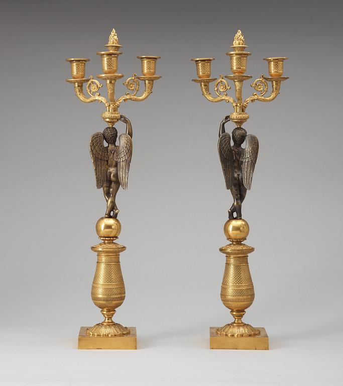 A pair of French Empire early 19th century three-light candelabra.