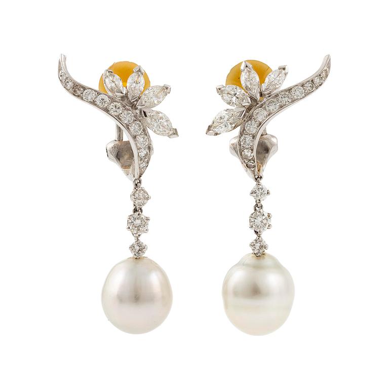 A pair of platinum earrings with cultured pearls and navette- and round brilliant-cut diamonds.