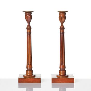 A pair of George III mahogany candlesticks, circa 1800.
