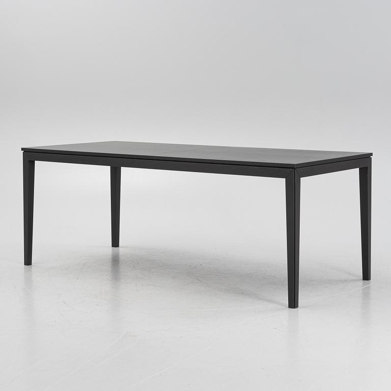 A black oak dining table with two additional leaves.