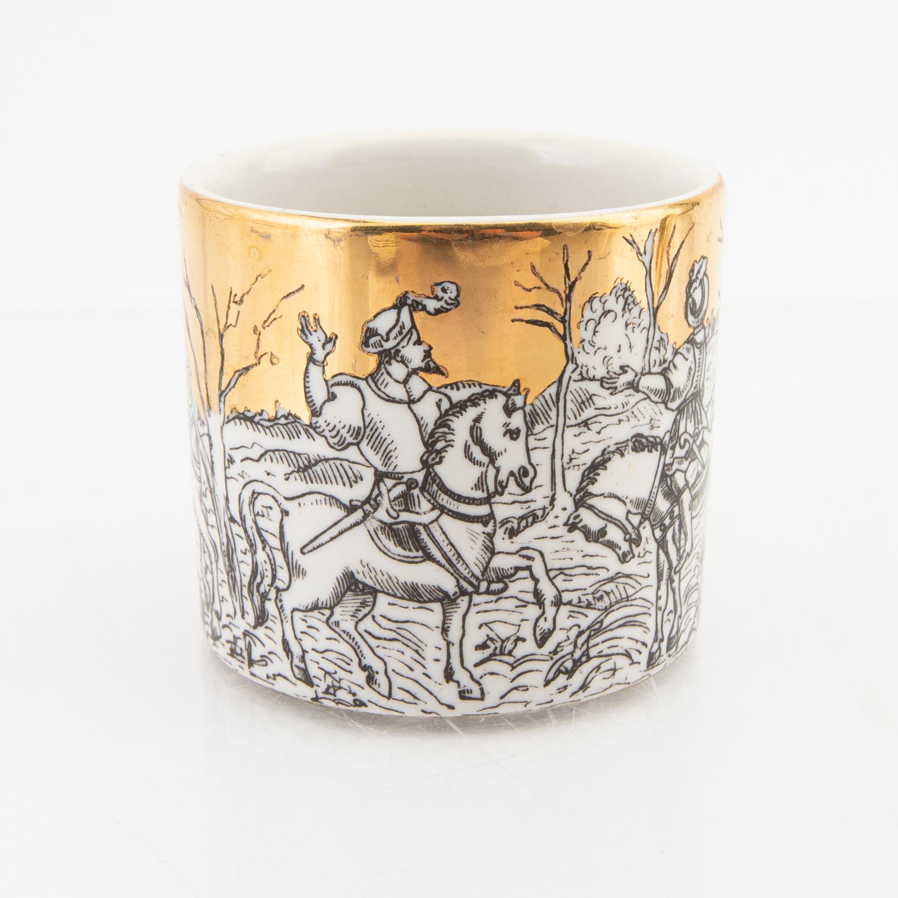 Piero Fornasetti, a set of eight small plates and a mug Italy mid 1900s.