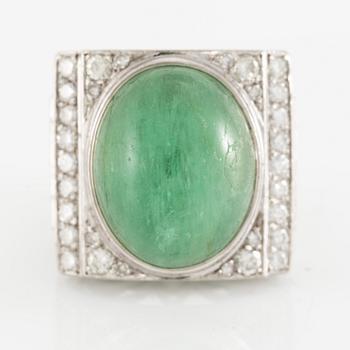 An 18K white gold ring set with a cabochon-cut emerald and round- and eight-cut diamonds.