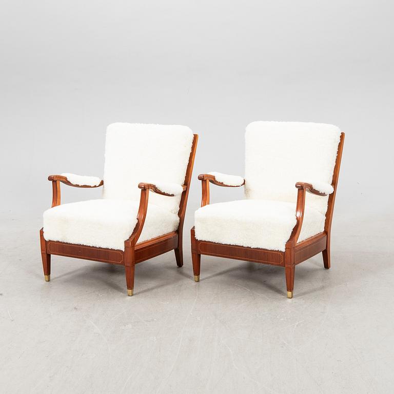 A pair of 1940s cheepskin armchairs.