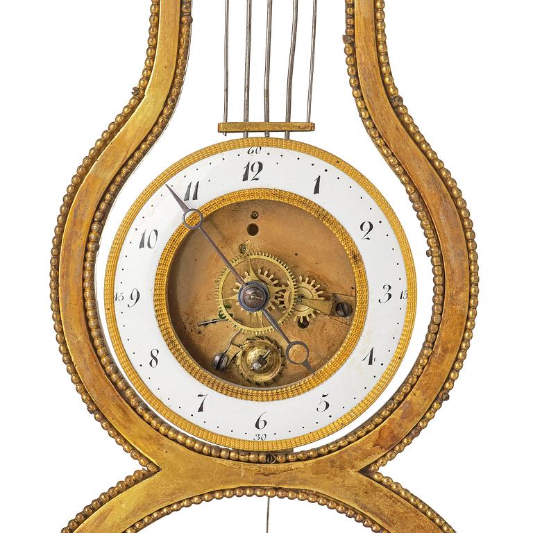 A French Louis XVI ormolu and marble lyre-shaped mantel clock, late 18th century.