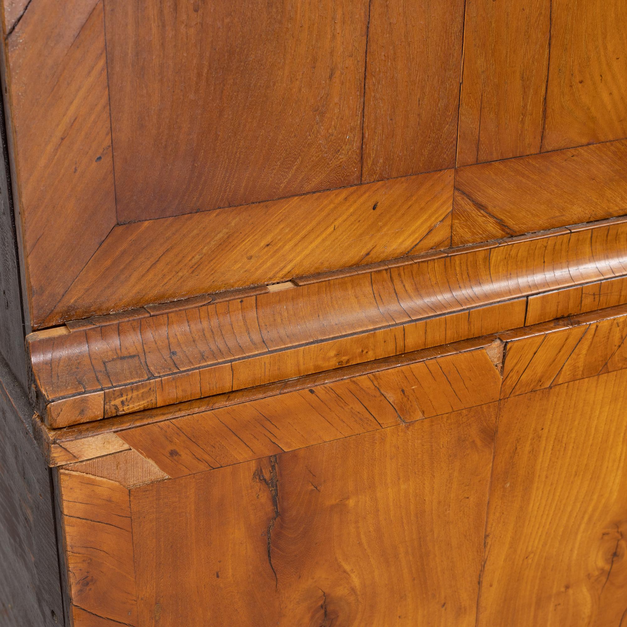 A walnut-veneered rococo cabinet in the manner of C. Linning, later part of the 18th Century.