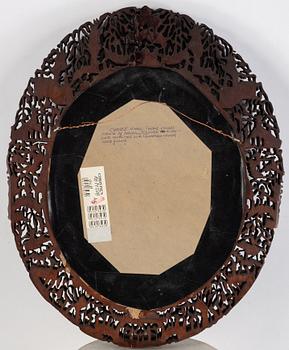 Chinese school, twelve small portraits of manchu aristocrats in a carved Cantonese frame, late Qing dynasty.