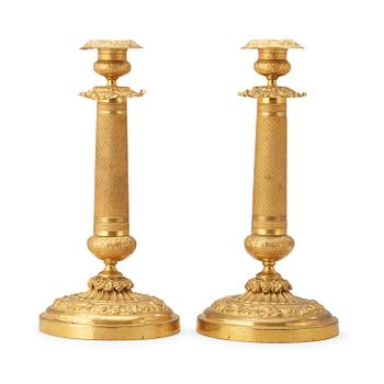 1297. A pair of Russian 1830/40's brass candlesticks.