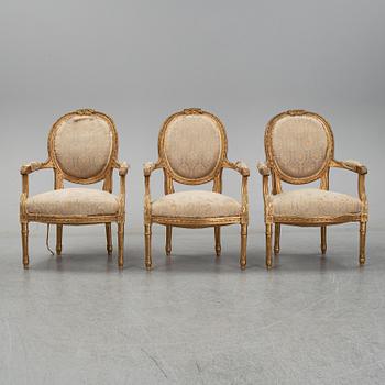 An early 20th century Louis XVI-style sofa and three chairs.