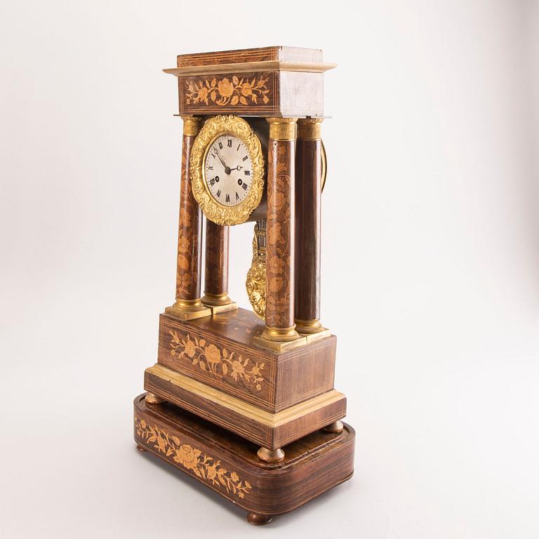 A late Empire mid 19th century veneered table clock.