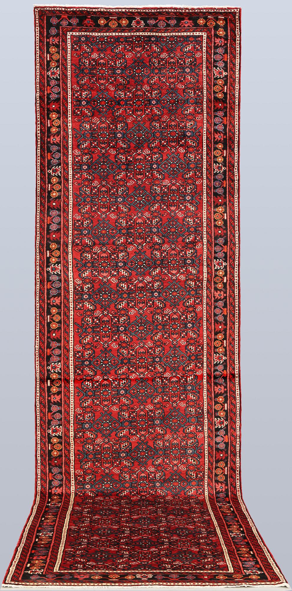 A Hosseinabad runner, c. 418 x 118 cm.