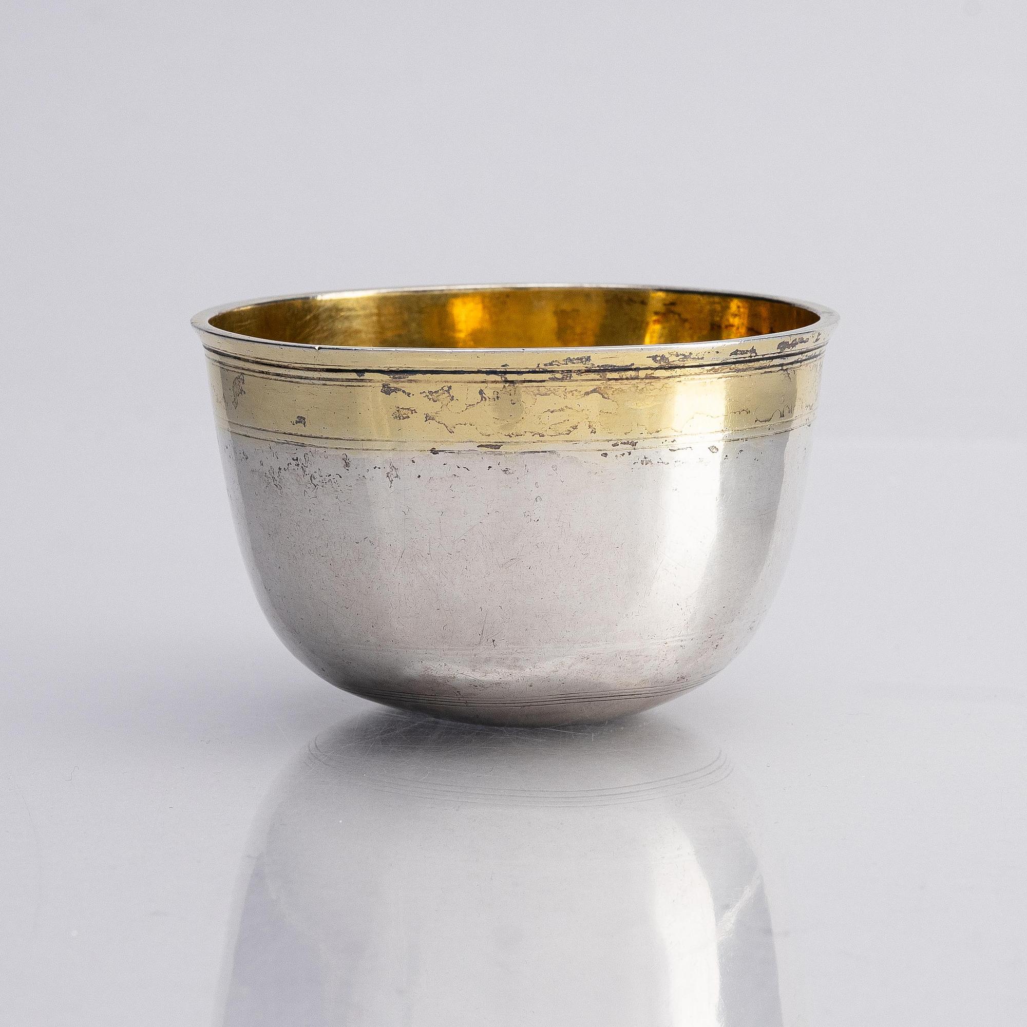 An Estonian parcel-gilt silver tumbler, mark of Jacob Fleischmann, (active in Arensburg 1675-1698).