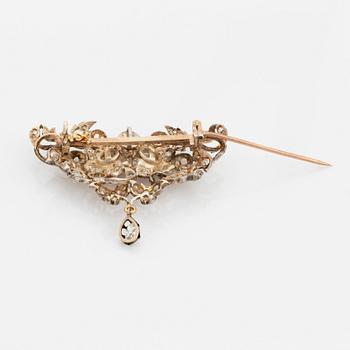 A silver brooch set with old-cut diamonds.