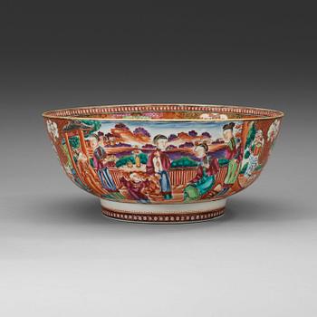 386. A large famille rose punch bowl, richly decorated with palace scenes, Qing dynasty, 18th century.