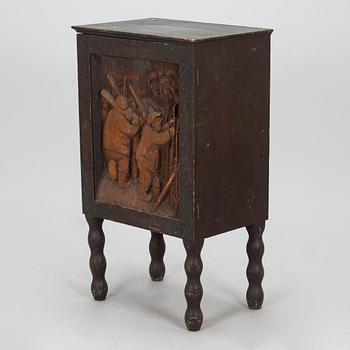 A 1920s cabinet with a relief.