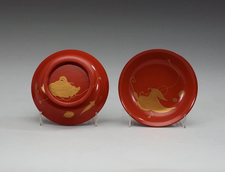 A set of eight red lacquered Japanese bowls with covers, first half of 20th Century.